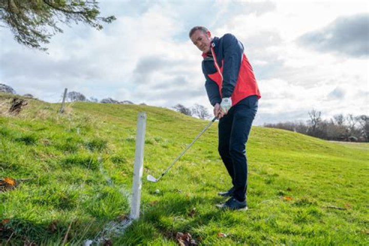 What is the rule for red stakes in golf?