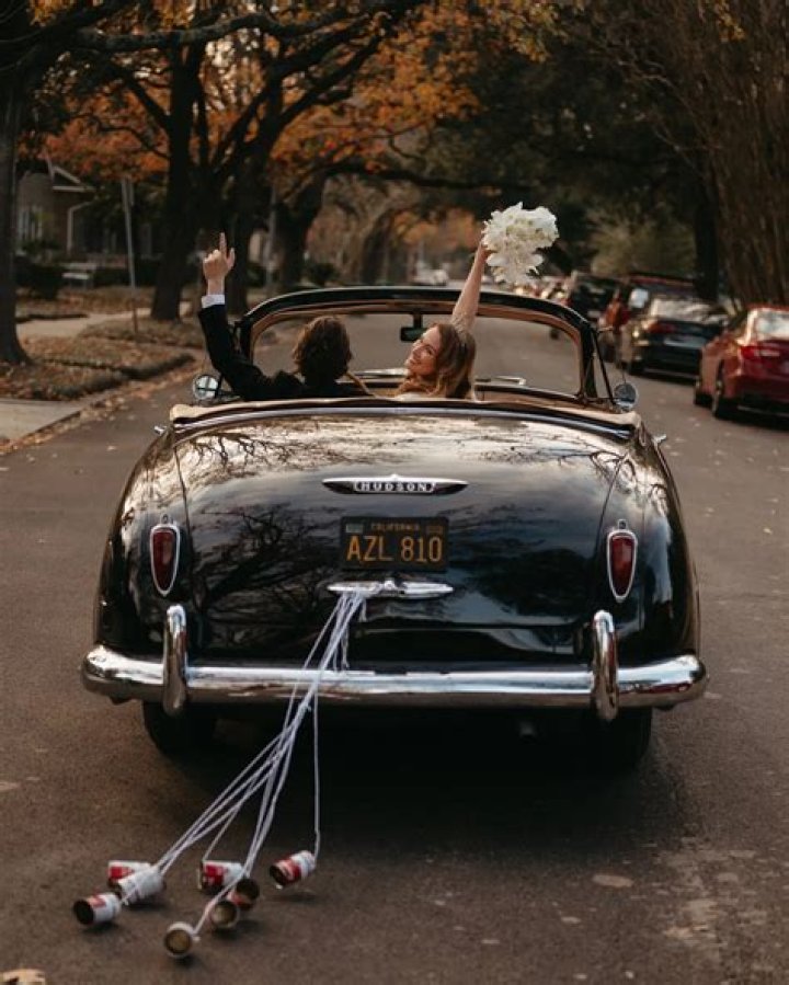 Why are cans tied to the wedding car?